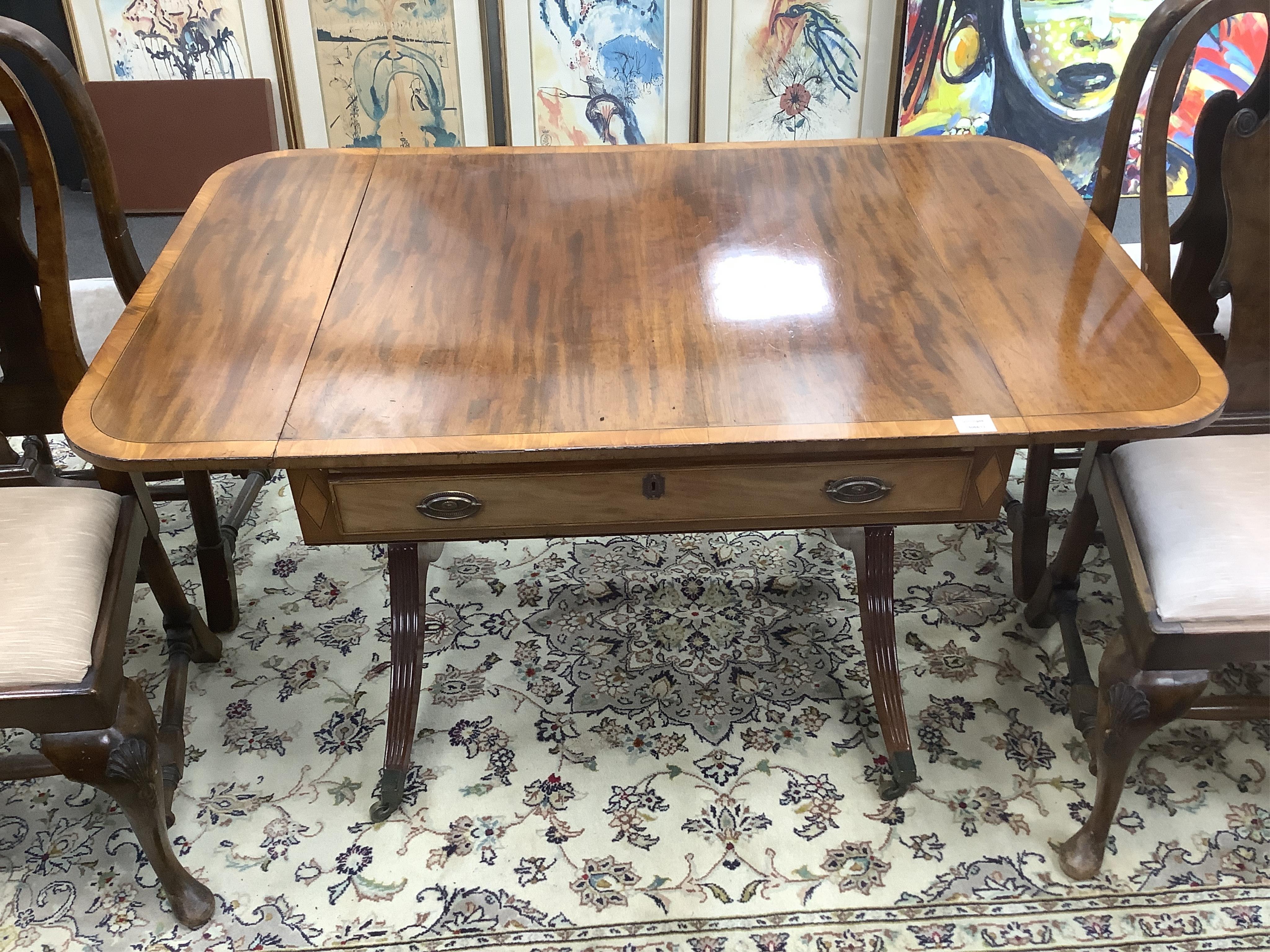 A Regency satinwood banded mahogany sofa table, width 132cm extended, depth 84cm, height 71cm. Condition - fair